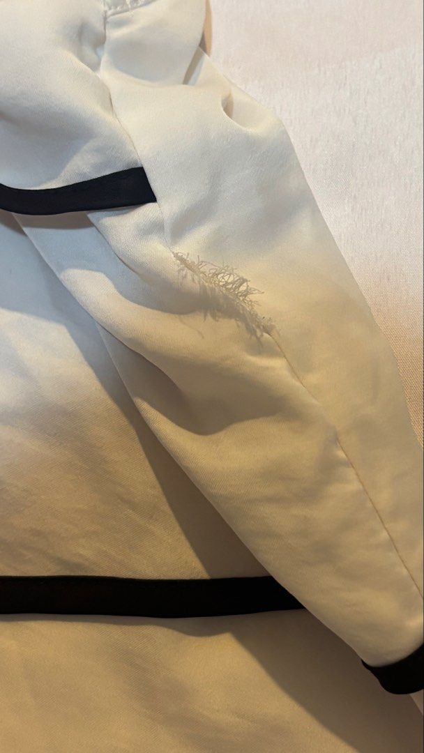 White Halter Neck Top with Black Trim (Category: Sleeveless) located in Quezon City. Submitted by cheech.01 (Listing ID 1467267334, Image 3). Description: - Style: White halter neck top with black piping on layered tiers and back tie closure - Material: Lightweight and comfortable fabric - Fit: Flattering halter cut, perfect for casual days or outings - Condition: Pre-loved with a small faint smudge on the back and minor frayed stitching near the