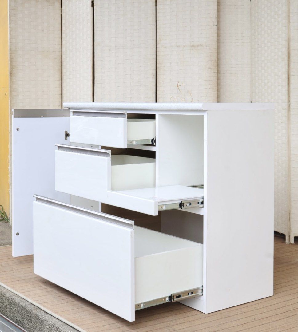 White Kitchen Island Cabinet Storage Unit with Drawers (Category: Shelves, Cabinets & Racks) located in Bulacan. Submitted by FurnitureGallery (Listing ID 1467307787, Image 2). Description: - White kitchen storage cabinet with elegant marble-look countertop - Features 3 smooth-glide drawers and a lower cabinet section - Handy open shelf space with a built-in electrical outlet for appliances - Sturdy, solid structure with a clean minimalist design