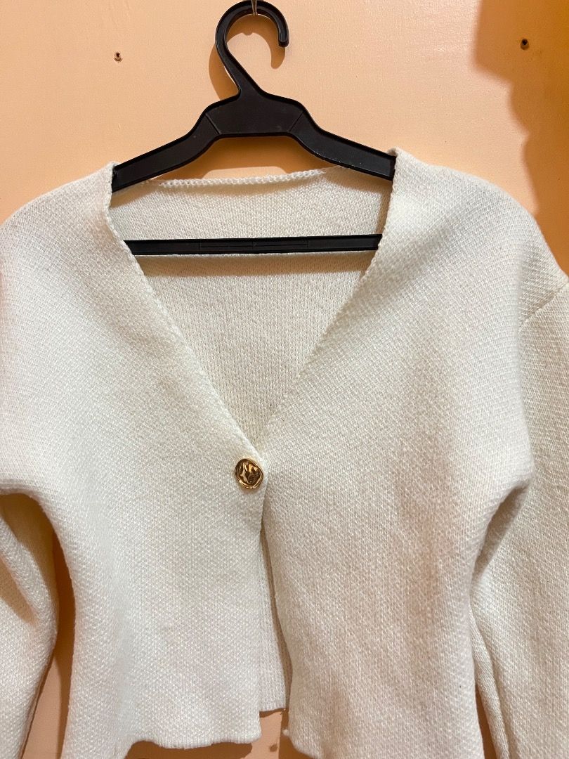 White Knit Cardigan with Gold Button (Category: Coats, Jackets and Outerwear) located in Davao. Submitted by rarefalcon.7d8ac4 (Listing ID 1467245245, Image 3). Description: - Color: Soft white - Style: Cropped knit cardigan with a deep V-neckline and long sleeves - Closure: Single textured gold metal button in the front - Material: Cozy, soft fabric ideal for layering - Condition: Brand new / Excellent (ready to wear).