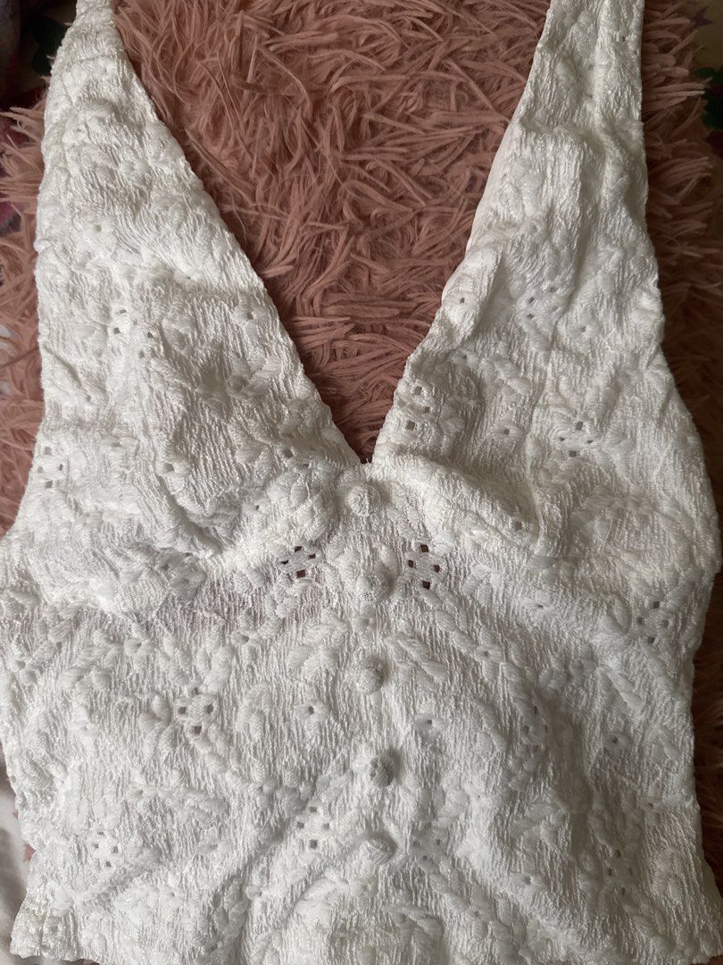 White lace halter top with button front (Category: Sleeveless) located in Manila. Submitted by elyseausti82909 (Listing ID 1467255708, Image 1). Description: handmade piece!! super pretty another fave 🥹 - Color: White - Material: Textured lace fabric - Design: Halter top with deep V-neck and fabric-covered front buttons - Fit: Sleeveless, thick straps, cropped length - Condition: Brand new, never worn out - Styling tip: Pairs perfectly with high