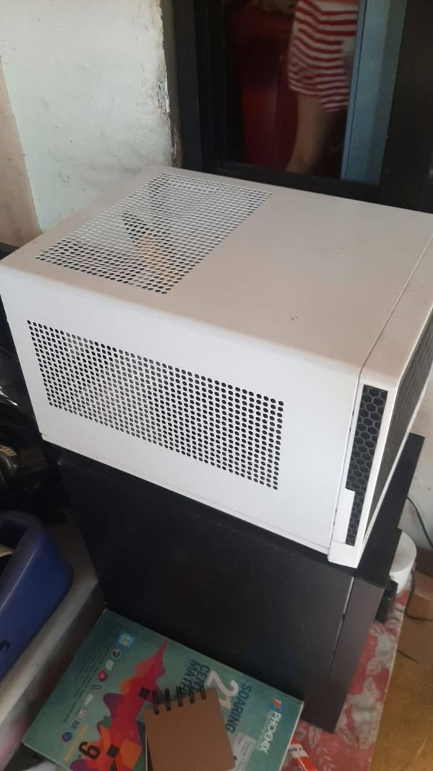 White Mini-ITX PC Computer Case (Category: Desktops) located in Caloocan City. Submitted by mx5a86 (Listing ID 1467180392, Image 3). Description: - Color: Clean minimalist white - Design: Compact mini-ITX/small form factor size - Ventilation: Mesh panels on top and side for maximum airflow - Layout: Includes rear I/O cutout and expansion slots - Management: Comes with internal wiring harness ready for your build.