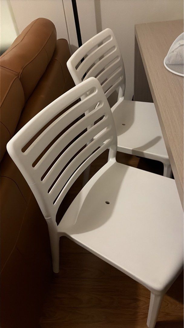 White Plastic Slatted Dining Chair (Category: Chairs) located in Makati City. Submitted by emsp24 (Listing ID 1467347011, Image 1). Description: - Set of 2 white plastic chairs - Used for 8 months - No issue - RFS: recently moved condo; medyo malaki para sa tirahan .