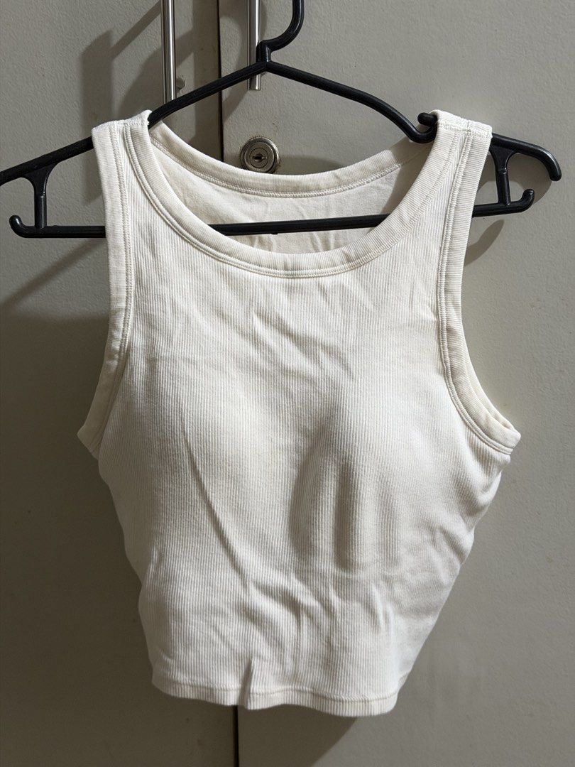 White ribbed tank top crop top (Category: Sleeveless) located in Manila. Submitted by karely (Listing ID 1467241968, Image 1). Description: - Color: White - Style: Ribbed cropped tank top with crew neckline and sleeveless design - Feature: Built-in padding for extra convenience - Material: Soft and stretchy cotton-blend fabric.