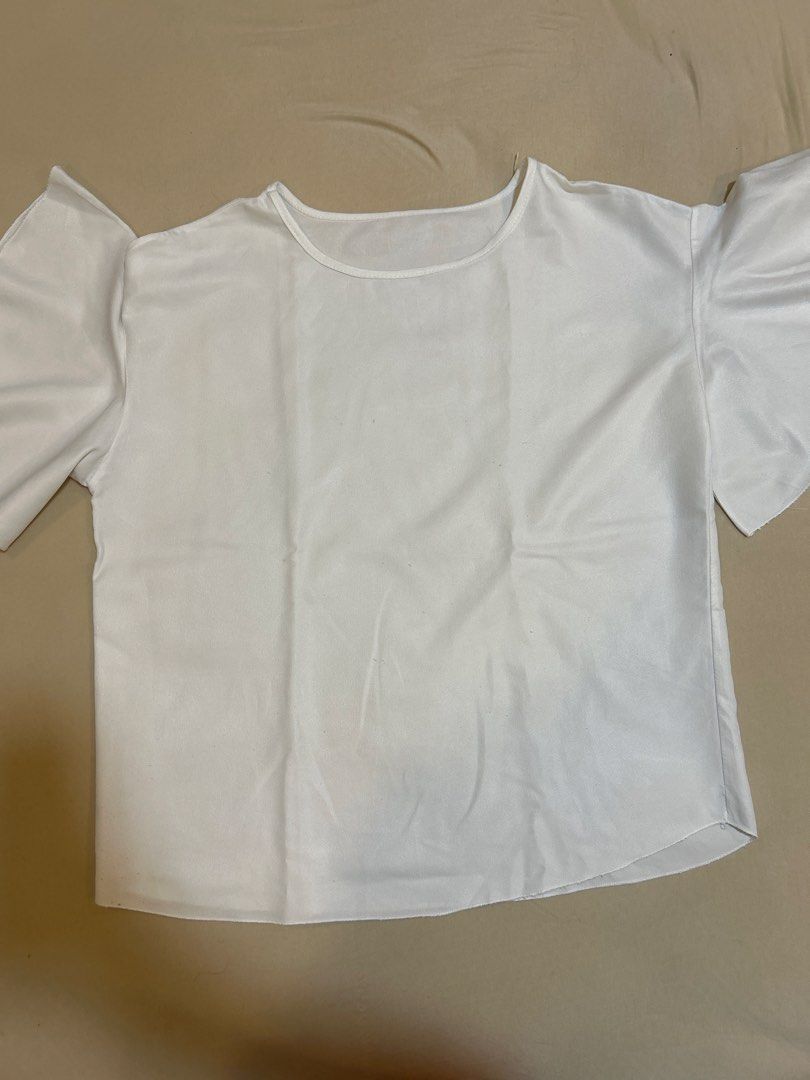 White Short Sleeve Blouse with Ruffle Cuffs (Category: Blouses) located in Quezon City. Submitted by kyokoaman (Listing ID 1467306522, Image 2). Description: - Color: Plain White - Design: Round neckline with trendy flared ruffle sleeves - Fit: Relaxed and comfortable through the body - Fabric: Lightweight and breathable - Styling: Easy to pair with jeans or skirts for effortless everyday outfits.