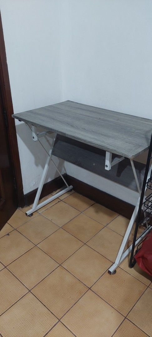 Wooden Study Desk with Metal Frame (Category: Office Furniture & Fixtures) located in Manila. Submitted by mcangwong80885 (Listing ID 1467203853, Image 2). Description: - Sturdy study desk with stylish grey wood-grain top - Convenient lower storage shelf for books and essentials - Solid build ready to use.