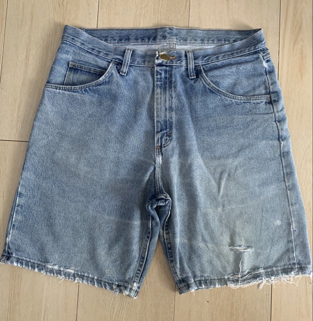 Wrangler Denim distressed shorts (Category: Shorts) located in Manila. Submitted by thrifty111 (Listing ID 1467177748, Image 1). Description: - Fit: Relaxed fit, heavyweight 100% cotton - Color/Wash: Light wash denim - Details: Distressed fraying hems, small rip on left leg - Features: Classic 5-pocket design, button fly closure - size 34-35 - Length 21” - leg opening 12”.