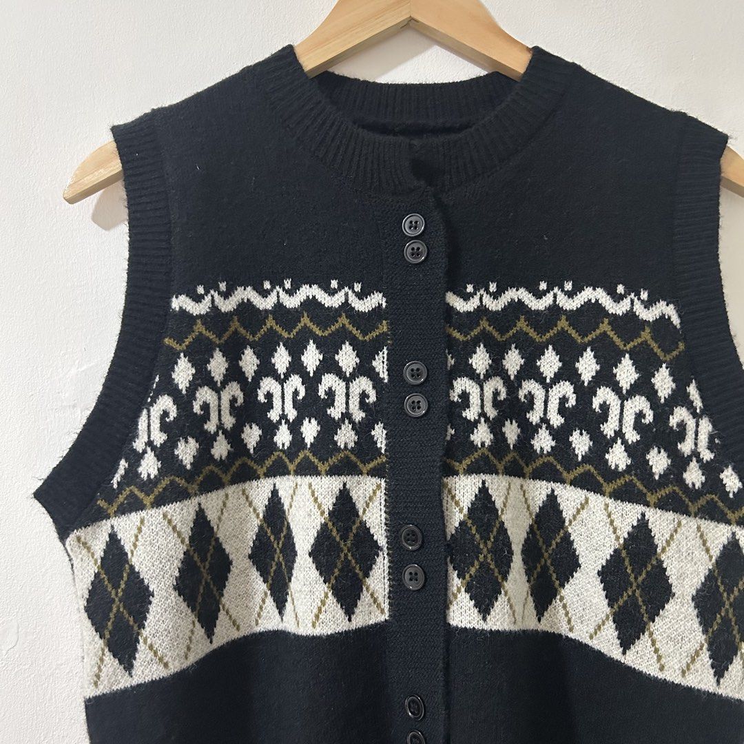 [XL] Black Patterned Button-Up Knitwear Sweater Vest (Category: Sleeveless) located in Tanza. Submitted by shop_qrated (Listing ID 1467260902, Image 3). Description: Black Patterned Button-Up Knitwear Sweater Vest. XL. Ganda but not my size so I am selling. This item appears to be a black button-up knit sweater vest featuring a white and gray argyle pattern across the chest and a Nordic-style geometric yoke detailing near the ribbed crew neckline