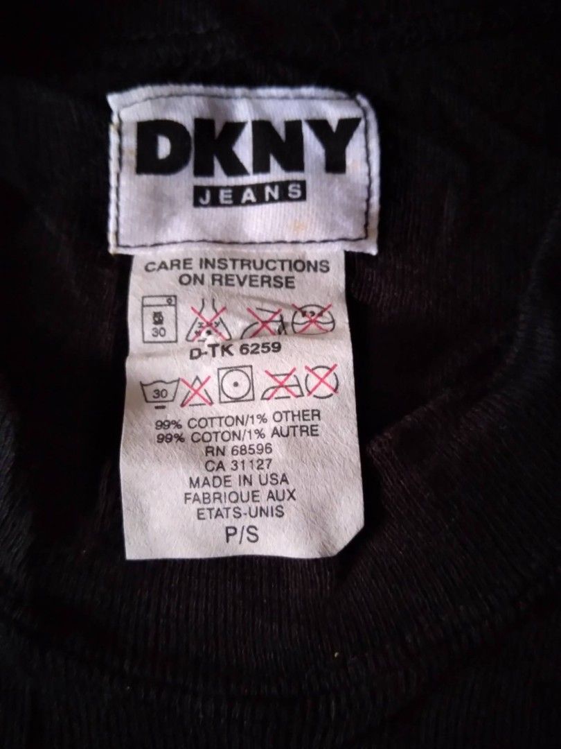 Y2k DKNY Black T-shirt Small (Category: Shirts) located in Zamboanga. Submitted by nurbya898048 (Listing ID 1467254222, Image 3). Description: Classic black DKNY Jeans short sleeve t-shirt. White and red graphic print on the front. Crew neck design, slim fit style. Tag says size P/S. Made in USA. 99 percent cotton, 1 percent other materials. Fabric feels soft and comfortable. Great Y2K aesthetic piece. Tag size small Excellent condition Presentab