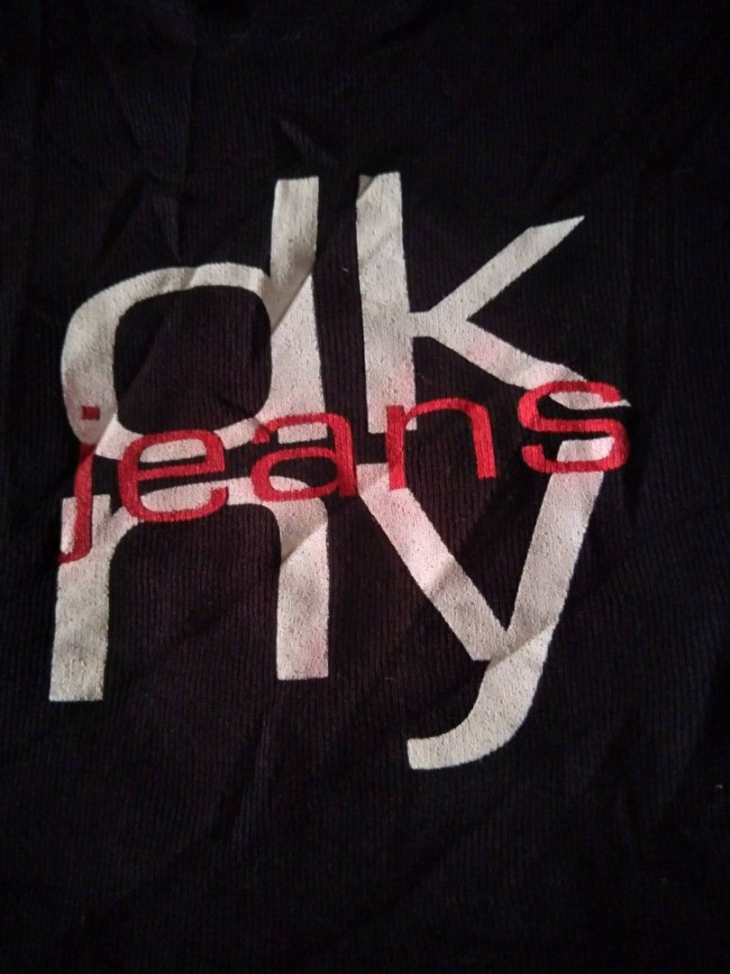 Y2k DKNY Black T-shirt Small (Category: Shirts) located in Zamboanga. Submitted by nurbya898048 (Listing ID 1467254222, Image 2). Description: Classic black DKNY Jeans short sleeve t-shirt. White and red graphic print on the front. Crew neck design, slim fit style. Tag says size P/S. Made in USA. 99 percent cotton, 1 percent other materials. Fabric feels soft and comfortable. Great Y2K aesthetic piece. Tag size small Excellent condition Presentab