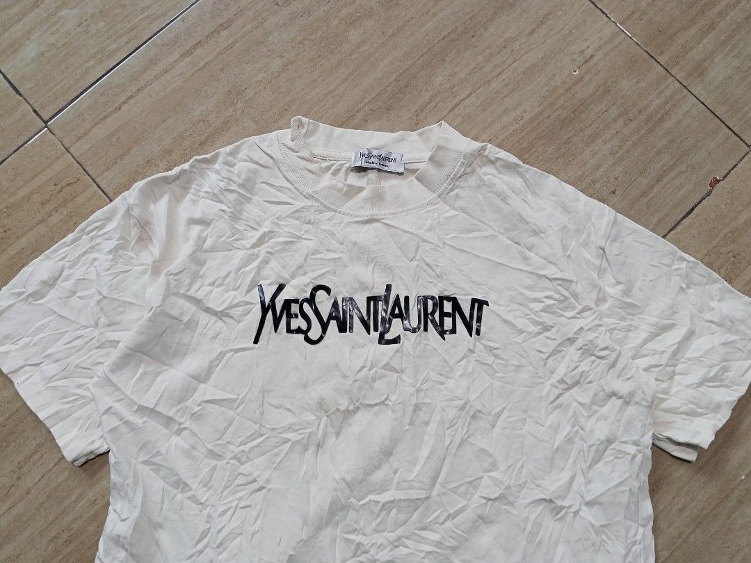 Yousaintlaurent (Category: Activewear) located in Glan. Submitted by cpaharodde48008 (Listing ID 1467230064, Image 3). Description: tshirt Unisex Tshirt Excellent condition Size Small to medium Width - 21 x Length - 21 Rubberized Logo.