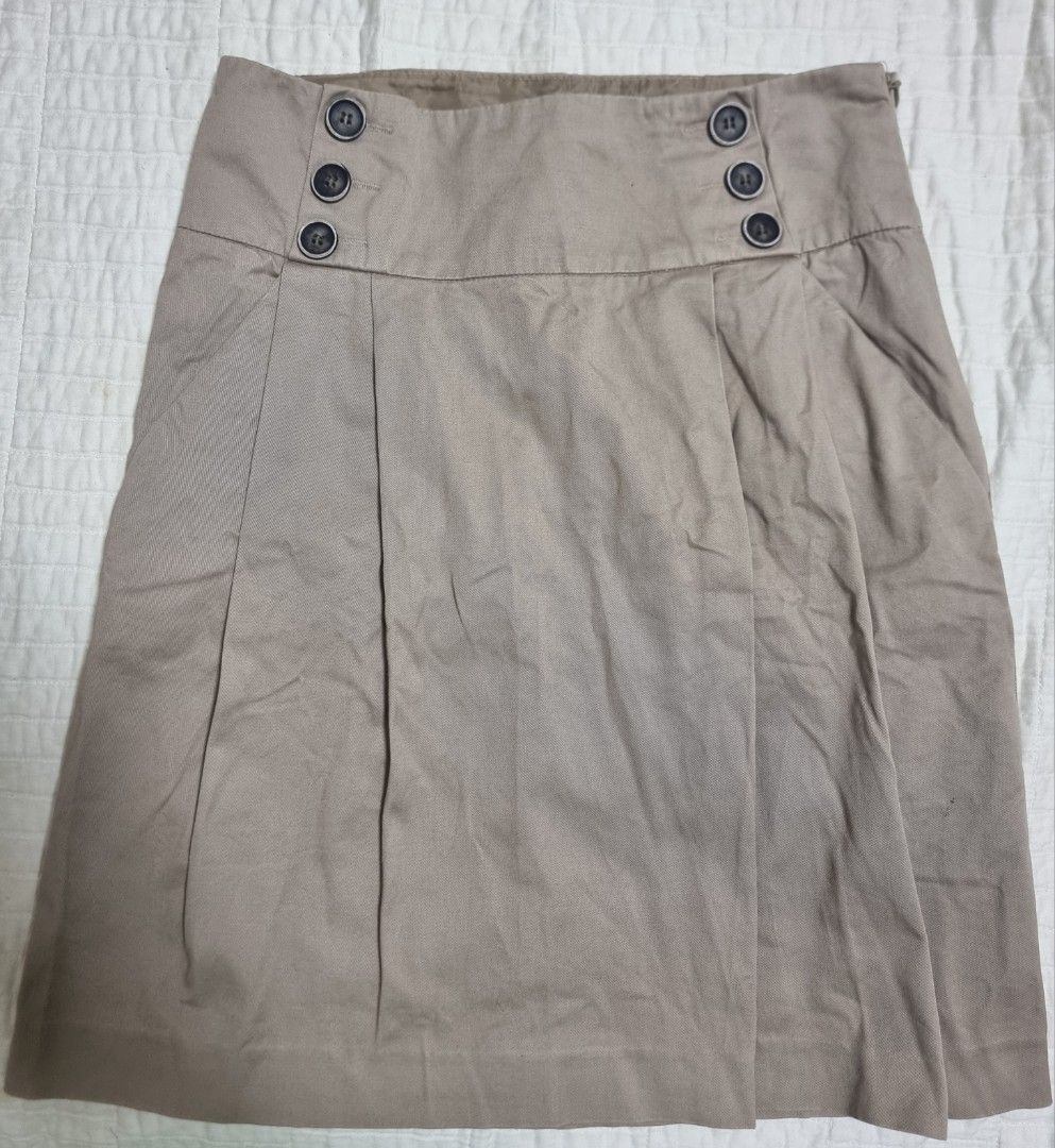 Zara Basic Beige Skirt Size XS (Category: Skirts) located in Narvacan. Submitted by 2ndchancefinder (Listing ID 1467297126, Image 1). Description: - Brand: Zara Basic - Size: XS - Color: Neutral beige / Earth tone - Material/Origin: Made in Indonesia - Style: High waist, wrap design with pleated front - Details: Three decorative buttons on both sides - Closure: Convenient side zip - Condition: Very good used condition, easy to match with any basi