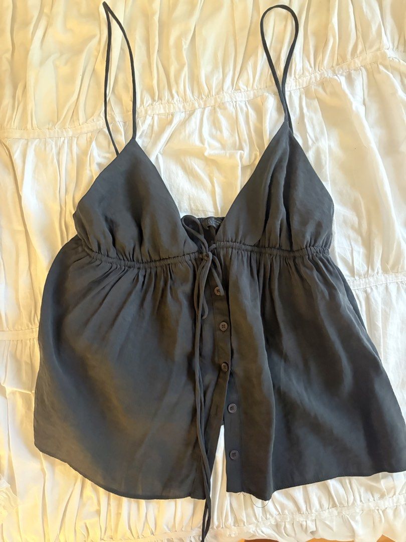 Zara Black Button-Front Camisole Cami Top (Category: Sleeveless) located in Makati City. Submitted by audrey.hepburn (Listing ID 1467263426, Image 1). Description: - Brand: Zara - Color: Classic Black - Style: V-neck camisole with adjustable tie closure - Details: Functional button-down front placket with dark buttons - Fit: Gathered under-bust peplum design for a flowy silhouette - Fabric: Lightweight, comfortable material perfect for local weat