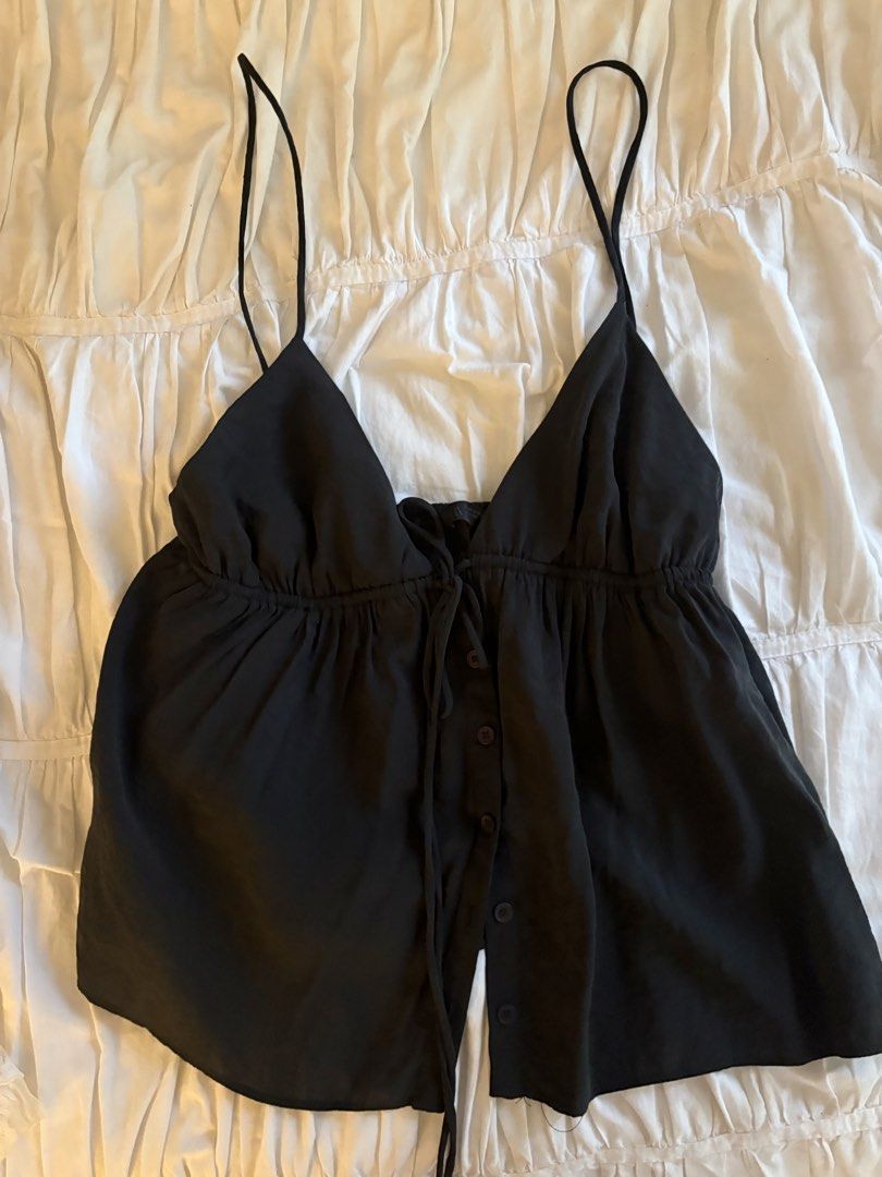 Zara Black Button-Front Camisole Cami Top (Category: Sleeveless) located in Makati City. Submitted by audrey.hepburn (Listing ID 1467263426, Image 3). Description: - Brand: Zara - Color: Classic Black - Style: V-neck camisole with adjustable tie closure - Details: Functional button-down front placket with dark buttons - Fit: Gathered under-bust peplum design for a flowy silhouette - Fabric: Lightweight, comfortable material perfect for local weat