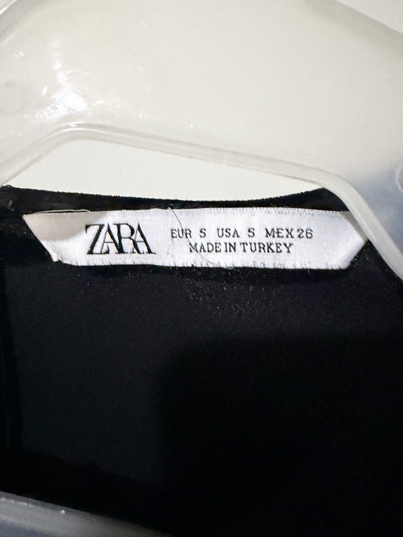 Zara Black Dress Size S (Category: Dresses) located in Mandaluyong City. Submitted by shopria0116 (Listing ID 1467284362, Image 3). Description: - Brand: Zara - Size: S (EUR S, USA S, MEX 26) - Made in Turkey - Color: Classic Black - Design: Short sleeves, round neckline, back zipper closure, and stylish pleated hem details - Condition: Clean and ready to wear - Versatile: Perfect for casual outings or work events.