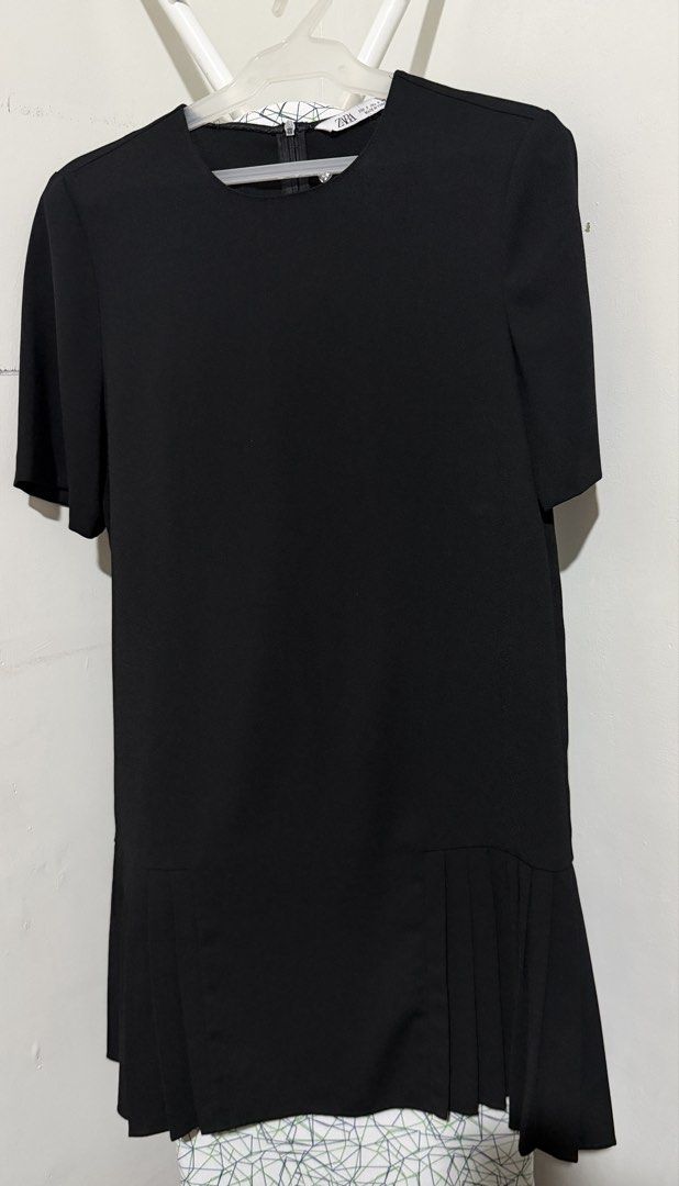 Zara Black Dress Size S (Category: Dresses) located in Mandaluyong City. Submitted by shopria0116 (Listing ID 1467284362, Image 1). Description: - Brand: Zara - Size: S (EUR S, USA S, MEX 26) - Made in Turkey - Color: Classic Black - Design: Short sleeves, round neckline, back zipper closure, and stylish pleated hem details - Condition: Clean and ready to wear - Versatile: Perfect for casual outings or work events.