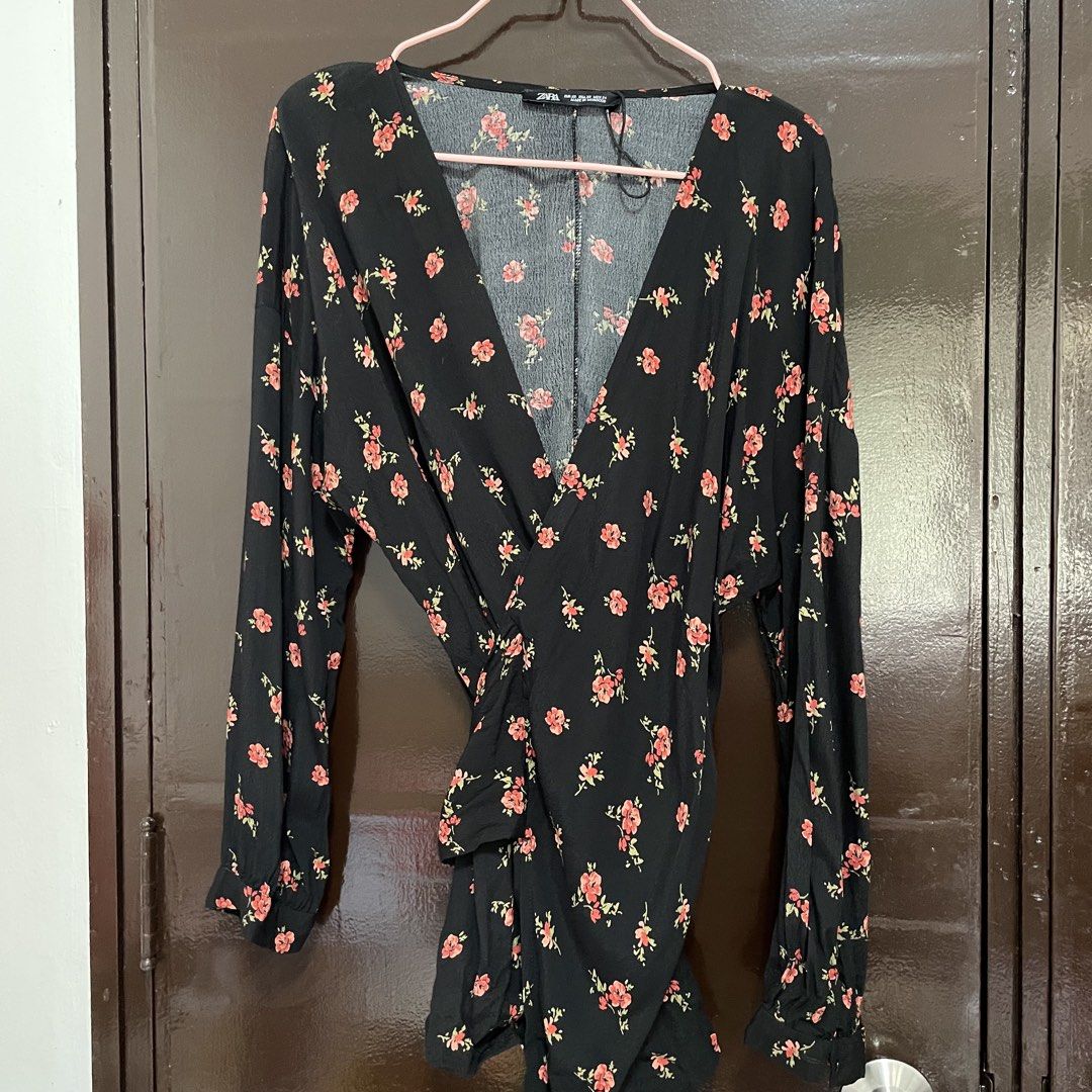 Zara Black Floral Wrap Blouse (Category: Blouses) located in Pasay City. Submitted by lovedbyzea (Listing ID 1467337593, Image 1). Description: - Linen-blend fabric - Brand: Zara - Style: Long sleeve wrap blouse with front gathered knot detail - Pattern: Red floral print with green leaves on black fabric - Neckline: V-neck - Size: EUR XS / USA XS - Origin: Made in Morocco - Lightweight and comfortable fabric.