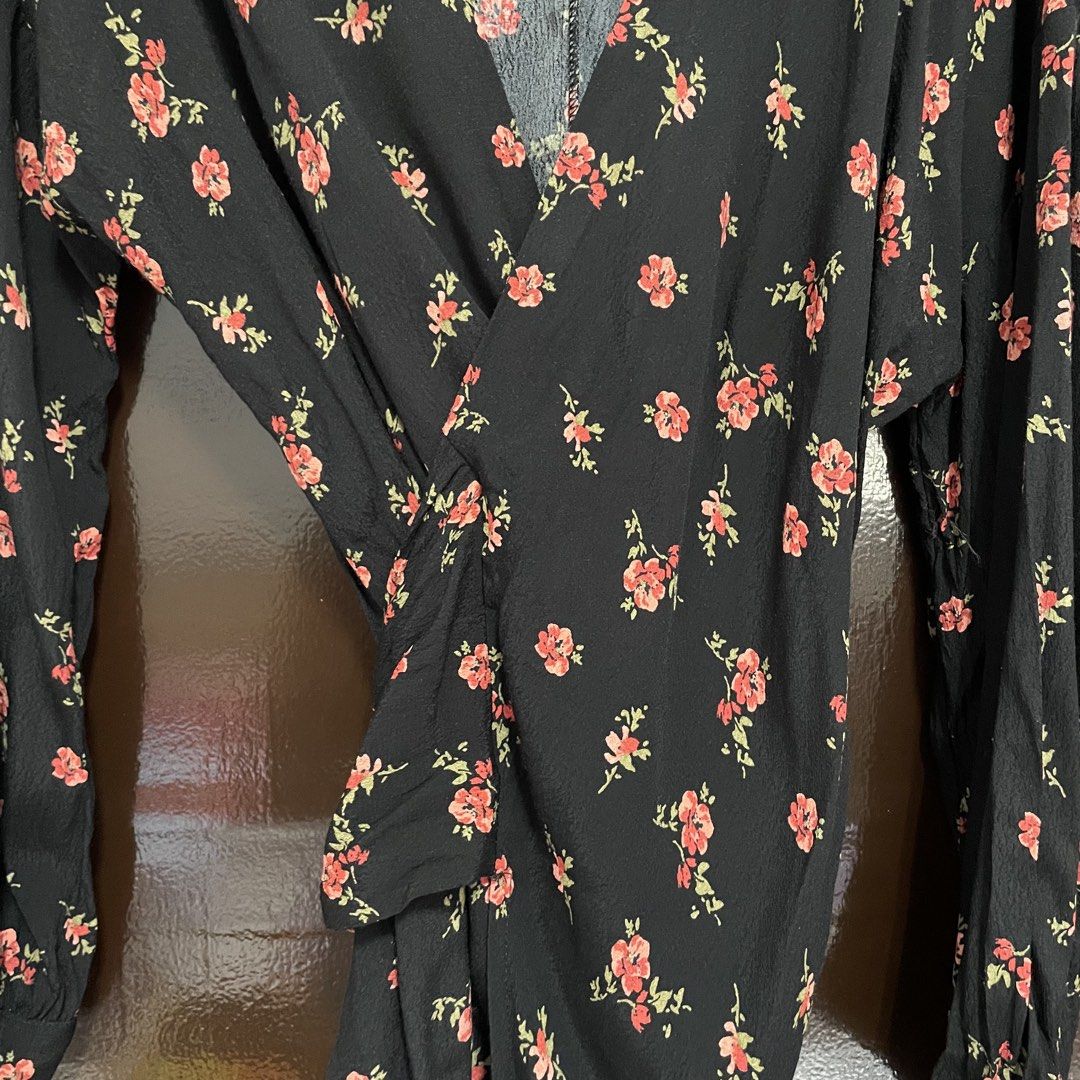 Zara Black Floral Wrap Blouse (Category: Blouses) located in Pasay City. Submitted by lovedbyzea (Listing ID 1467337593, Image 3). Description: - Linen-blend fabric - Brand: Zara - Style: Long sleeve wrap blouse with front gathered knot detail - Pattern: Red floral print with green leaves on black fabric - Neckline: V-neck - Size: EUR XS / USA XS - Origin: Made in Morocco - Lightweight and comfortable fabric.