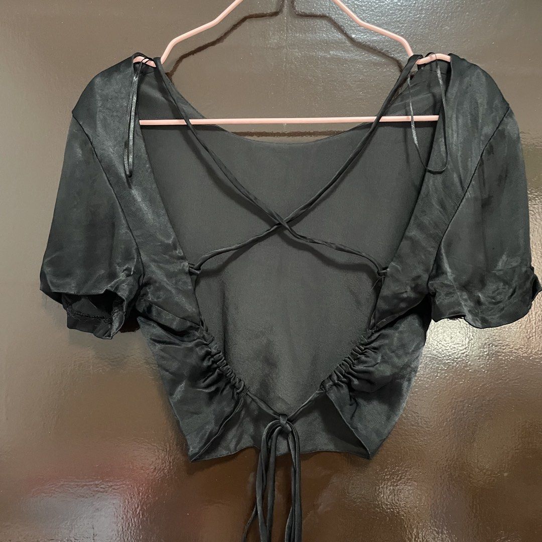 Zara Black Satin Open Back Crop Top (Category: Blouses) located in Pasay City. Submitted by lovedbyzea (Listing ID 1467343447, Image 2). Description: - Brand: Zara - Size: Medium (M) - Color: Black - Material: Smooth satin with a slight sheen (Made in Morocco) - Neckline: Front scoop neckline - Back Details: Dramatic open back with thin criss-cross straps - Fit Features: Side ruching and adjustable tie closure at the hem - Condition: Excellent / 