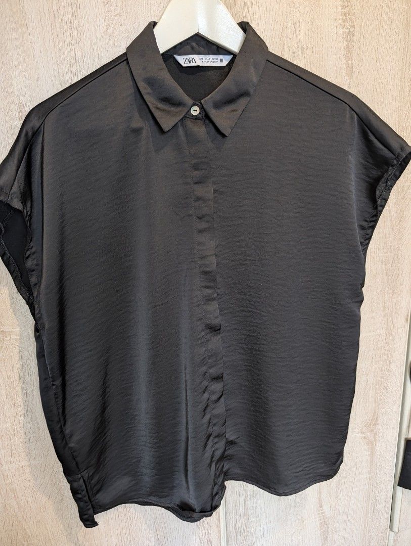 Zara Womens Black Satin Collared Blouse (Category: Blouses) located in Manila. Submitted by cart_rd (Listing ID 1467203515, Image 1). Description: - Brand: Zara - Color: Black - Size: Small (S) - Material: Satin - Design: Short dolman sleeves, collared neckline, front button placket with hidden buttons, and a box pleat on the back yoke for a relaxed fit - Origin: Made in Cambodia - pls see last photo for minor wear sign, tiny snag hole on the col