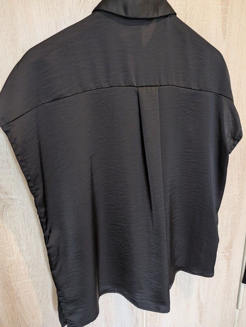 Zara Womens Black Satin Collared Blouse (Category: Blouses) located in Manila. Submitted by cart_rd (Listing ID 1467203515, Image 2). Description: - Brand: Zara - Color: Black - Size: Small (S) - Material: Satin - Design: Short dolman sleeves, collared neckline, front button placket with hidden buttons, and a box pleat on the back yoke for a relaxed fit - Origin: Made in Cambodia - pls see last photo for minor wear sign, tiny snag hole on the col
