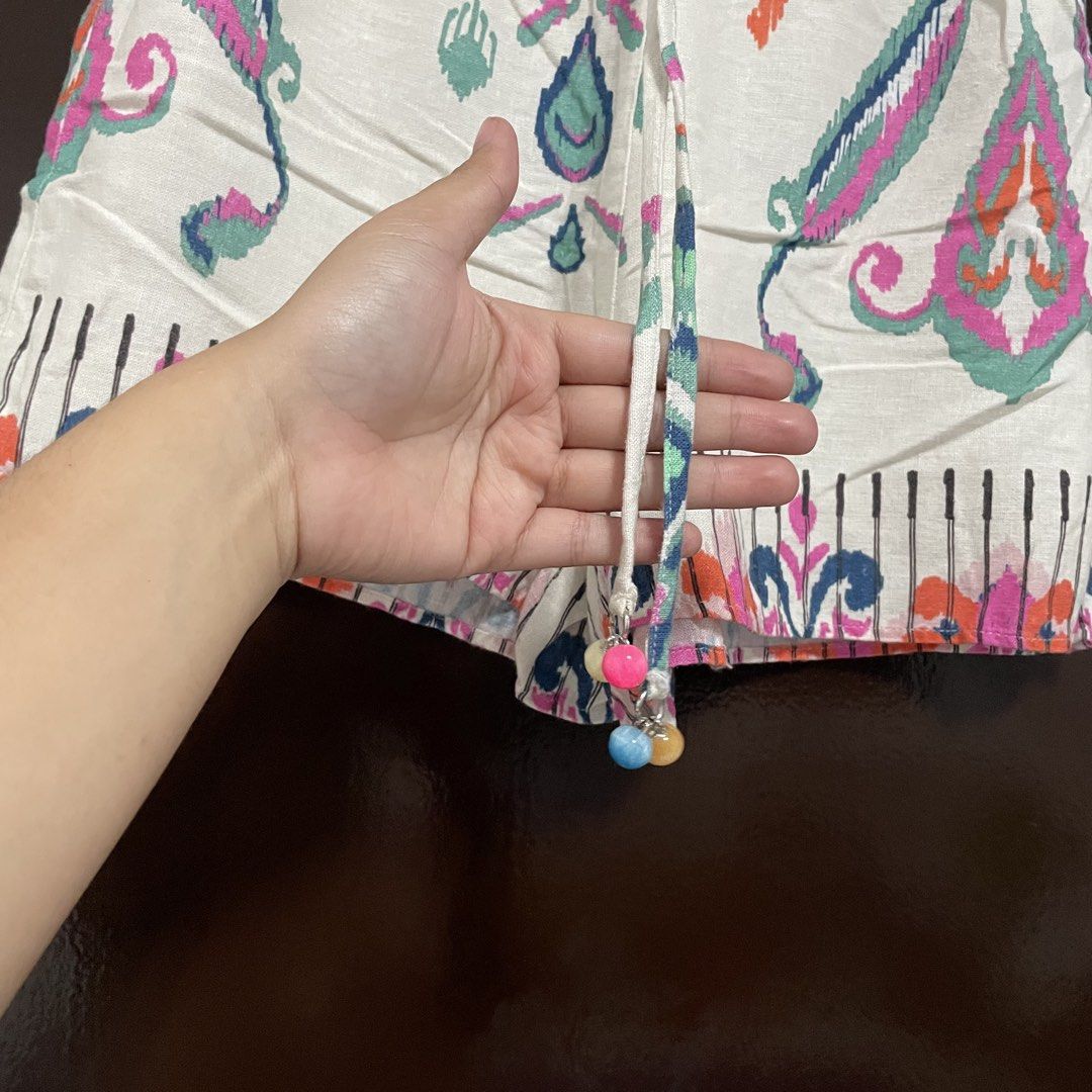 Zara Boho Printed Drawstring Shorts with Beaded Tassels (Category: Shorts) located in Pasay City. Submitted by lovedbyzea (Listing ID 1467344279, Image 2). Description: - Style: Fun, breezy boho shorts - Color/Pattern: Cream base with colorful pink, blue, and orange paisley print - Waistband: Comfortable elastic with adjustable drawstring and beaded charms - Fabric: Light, airy, and perfect for warm weather - Details: Cute patterned hem border, e