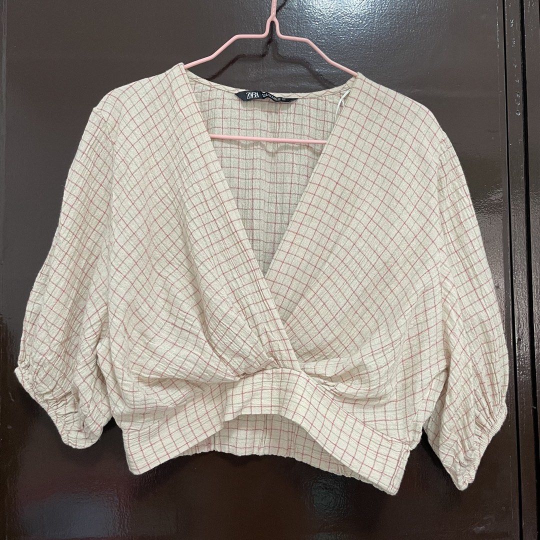 Zara Checkered Wrap Crop Blouse (Category: Blouses) located in Pasay City. Submitted by lovedbyzea (Listing ID 1467342212, Image 1). Description: - Brand: Zara - Size: S - Color/Pattern: Cream with pink and green check - Details: V-neckline with wrap front twist, short puffed sleeves with elastic cuffs, textured gauze fabric - Origin: Made in Morocco.