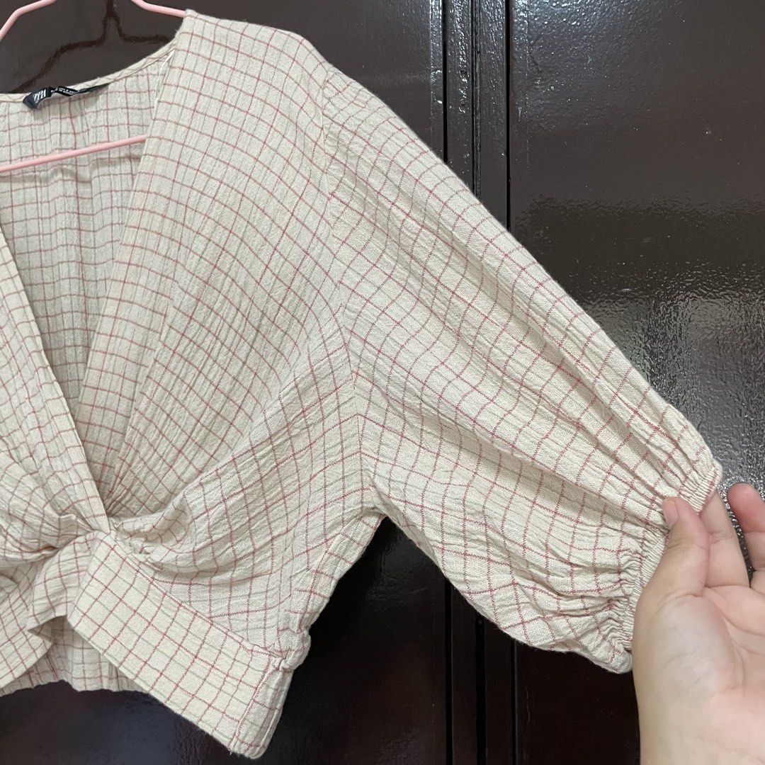 Zara Checkered Wrap Crop Blouse (Category: Blouses) located in Pasay City. Submitted by lovedbyzea (Listing ID 1467342212, Image 3). Description: - Brand: Zara - Size: S - Color/Pattern: Cream with pink and green check - Details: V-neckline with wrap front twist, short puffed sleeves with elastic cuffs, textured gauze fabric - Origin: Made in Morocco.