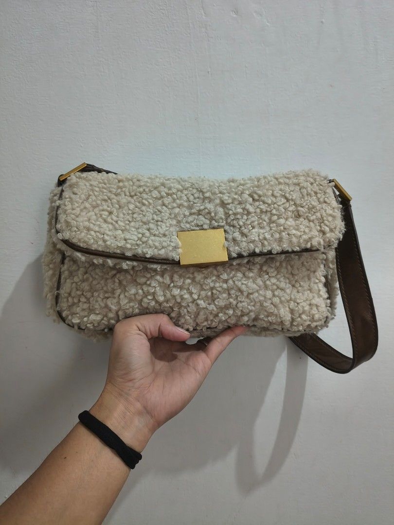 Zara Faux Shearling Flap Shoulder Bag (Category: Shoulder Bags) located in Tanza. Submitted by mharicor1589643 (Listing ID 1467330948, Image 2). Description: - Brand: Zara - Material: Fluffy cream faux shearling with brown faux leather trim - Hardware: Gold-tone square magnetic closure - Interior: Dark fabric lining with Zara brand patch, very clean - Style: Structured rectangular shoulder bag - Condition: Excellent, clean inside and out - Perfec