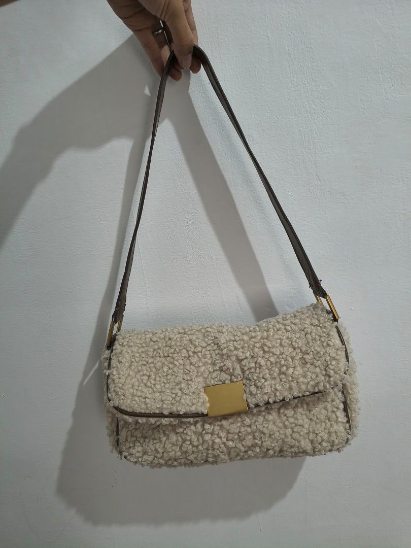 Zara Faux Shearling Flap Shoulder Bag (Category: Shoulder Bags) located in Tanza. Submitted by mharicor1589643 (Listing ID 1467330948, Image 1). Description: - Brand: Zara - Material: Fluffy cream faux shearling with brown faux leather trim - Hardware: Gold-tone square magnetic closure - Interior: Dark fabric lining with Zara brand patch, very clean - Style: Structured rectangular shoulder bag - Condition: Excellent, clean inside and out - Perfec