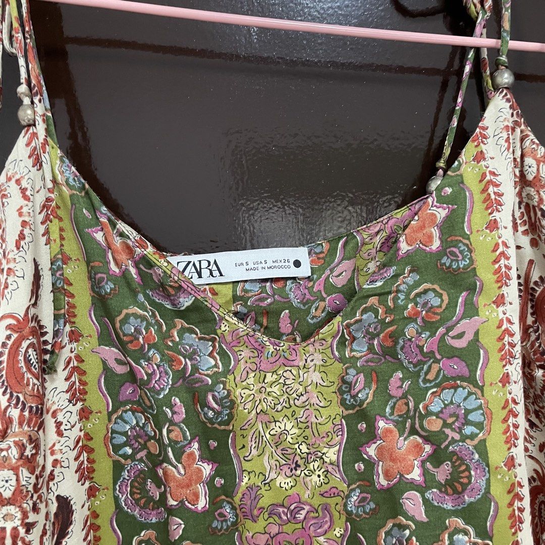 Zara Floral Boho Cami Top Size S (Category: Sleeveless) located in Pasay City. Submitted by lovedbyzea (Listing ID 1467343739, Image 3). Description: - Brand: Zara - Size: S - Design: Green, pink, and white floral & paisley print panels - Neckline/Straps: V-neck with adjustable tie straps and bead details - Material: Lightweight fabric - Origin: Made in Morocco - Condition: Great for warm weather or layering.