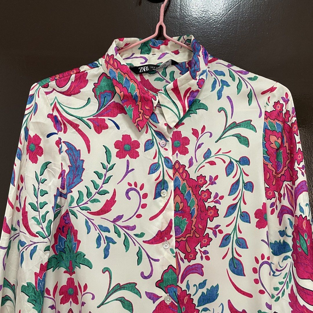 Zara Floral Pattern Long Sleeve Button-Down Blouse (Category: Longsleeves) located in Pasay City. Submitted by lovedbyzea (Listing ID 1467337087, Image 2). Description: - Brand: Zara - Size: S (Made in Morocco) - Color/Pattern: White base with vibrant pink, green, and blue floral and paisley prints - Details: Standard collar, button-down front, long sleeves with button cuffs - Condition: Excellent pre-loved condition - Mode of Payment: BPI, GCash