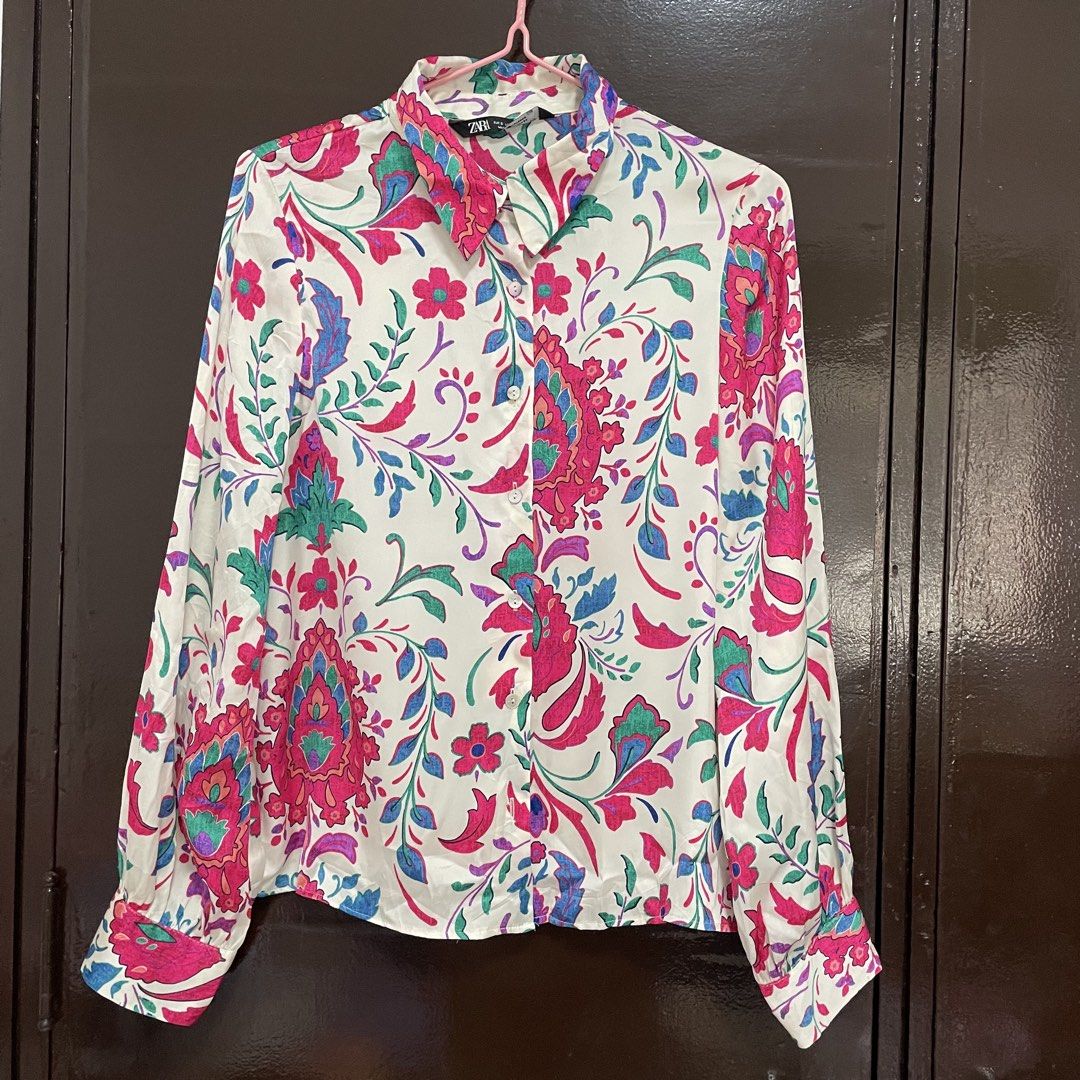 Zara Floral Pattern Long Sleeve Button-Down Blouse (Category: Longsleeves) located in Pasay City. Submitted by lovedbyzea (Listing ID 1467337087, Image 1). Description: - Brand: Zara - Size: S (Made in Morocco) - Color/Pattern: White base with vibrant pink, green, and blue floral and paisley prints - Details: Standard collar, button-down front, long sleeves with button cuffs - Condition: Excellent pre-loved condition - Mode of Payment: BPI, GCash