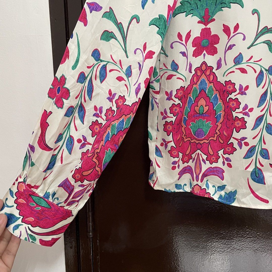 Zara Floral Pattern Long Sleeve Button-Down Blouse (Category: Longsleeves) located in Pasay City. Submitted by lovedbyzea (Listing ID 1467337087, Image 3). Description: - Brand: Zara - Size: S (Made in Morocco) - Color/Pattern: White base with vibrant pink, green, and blue floral and paisley prints - Details: Standard collar, button-down front, long sleeves with button cuffs - Condition: Excellent pre-loved condition - Mode of Payment: BPI, GCash