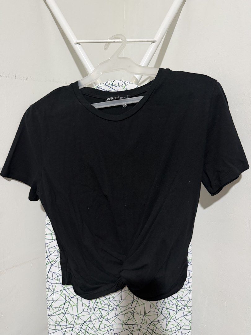 Zara Front Knot T-shirt Bundle Black White Size L (Category: Shirts) located in Mandaluyong City. Submitted by shopria0116 (Listing ID 1467285039, Image 1). Description: - Set of 2 Zara t-shirts (Black and White) - Size: Large (Made in Bangladesh) - Design: Classic crew neck, short sleeves, and trendy front knot detail at the hem - Material: Comfortable everyday fabric - Styling: Easy to pair with jeans or skirts for casual daily outfits - Bundle