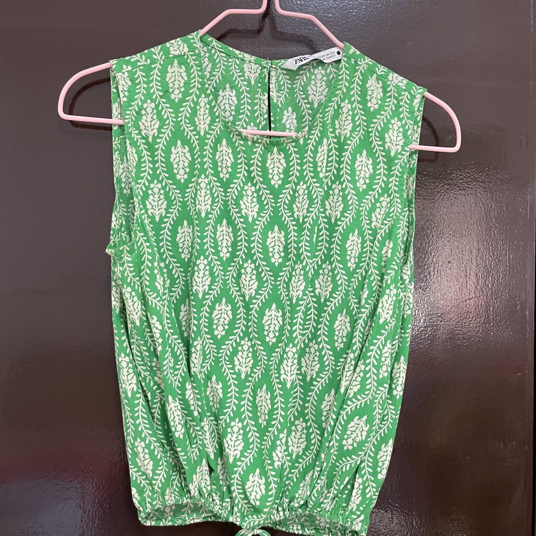 Zara Green Patterned Sleeveless Drawstring Top (Category: Sleeveless) located in Pasay City. Submitted by lovedbyzea (Listing ID 1467343904, Image 2). Description: - Brand: Zara - Size: XS - Design: Green and white botanical pattern, round neckline with back button - Features: Lightweight fabric, elasticated hem with adjustable drawstring ties.