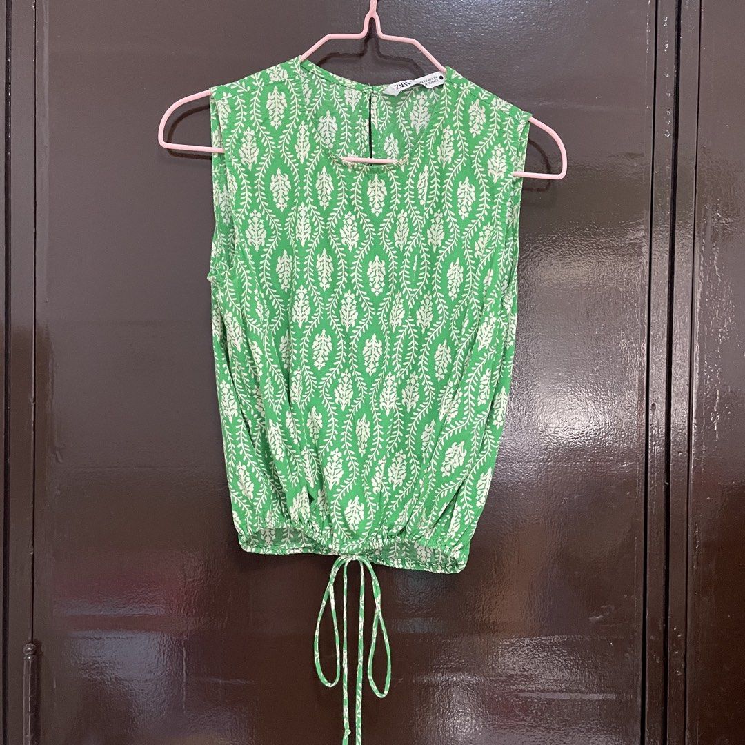Zara Green Patterned Sleeveless Drawstring Top (Category: Sleeveless) located in Pasay City. Submitted by lovedbyzea (Listing ID 1467343904, Image 1). Description: - Brand: Zara - Size: XS - Design: Green and white botanical pattern, round neckline with back button - Features: Lightweight fabric, elasticated hem with adjustable drawstring ties.