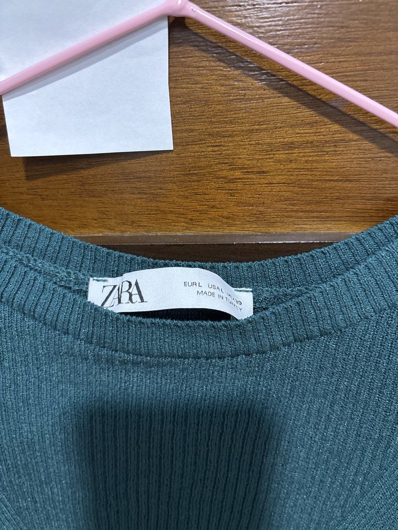 Zara Green Ribbed Knit Top Size L (Category: Sleeveless) located in Mandaluyong City. Submitted by clothescarousel (Listing ID 1467240210, Image 2). Description: - Brand: Zara - Style: Ribbed knit top with subtle chevron pattern on chest - Color: Dark Green - Size: Large (L) - Details: Short sleeves, crew neckline, soft stretch fabric - Origin: Made in Turkey - Condition: Good overall.