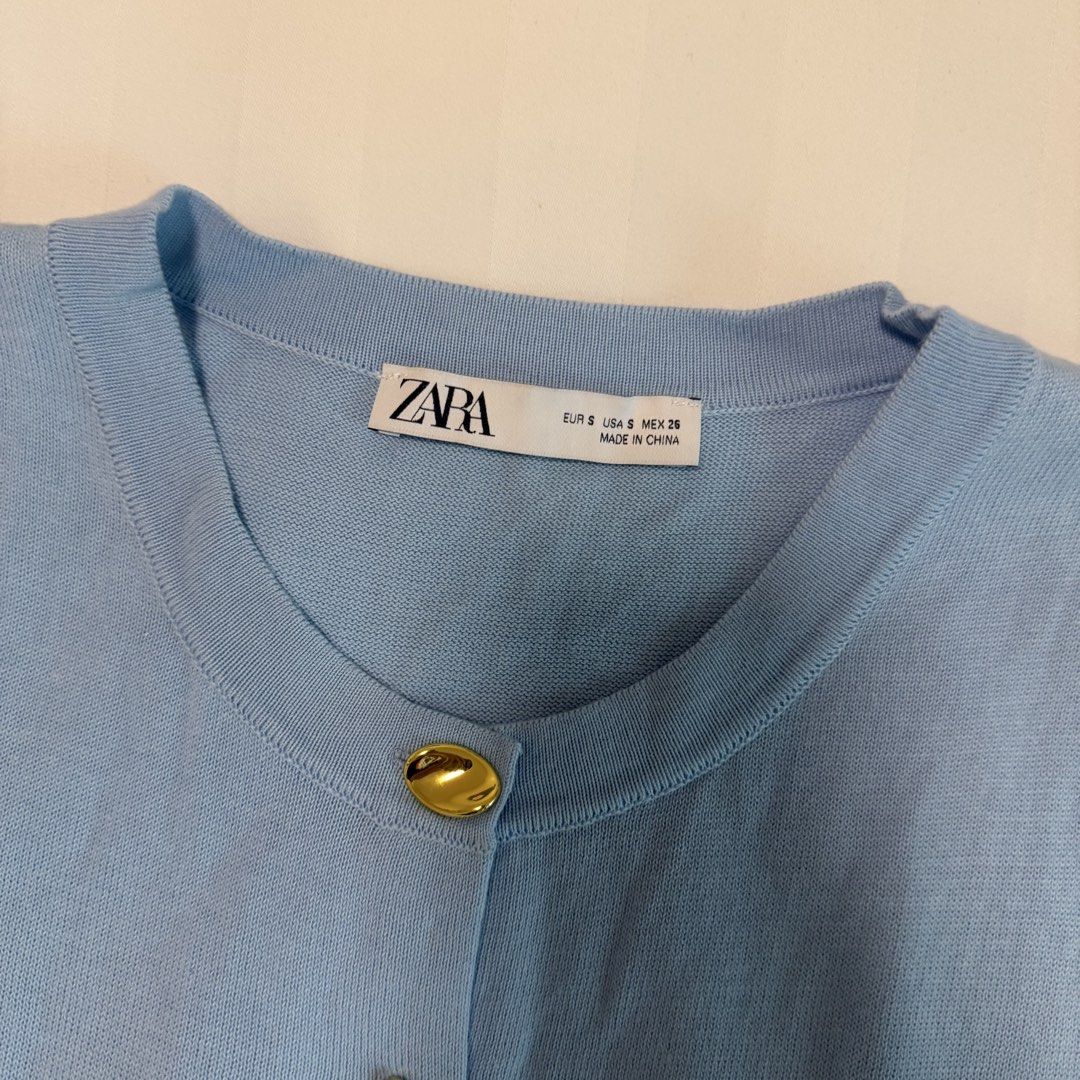 Zara Light Blue Knit Sleeveless Cardigan (Category: Sleeveless) located in Makati City. Submitted by agl.ph (Listing ID 1467359708, Image 3). Description: - Brand: Zara - Size: Small (S) - Color: Baby blue - Worn once - Material: Soft knit - Design: Round neckline, sleeveless, full button front - Details: Eye-catching shiny gold metallic buttons, ribbed hem and collar.