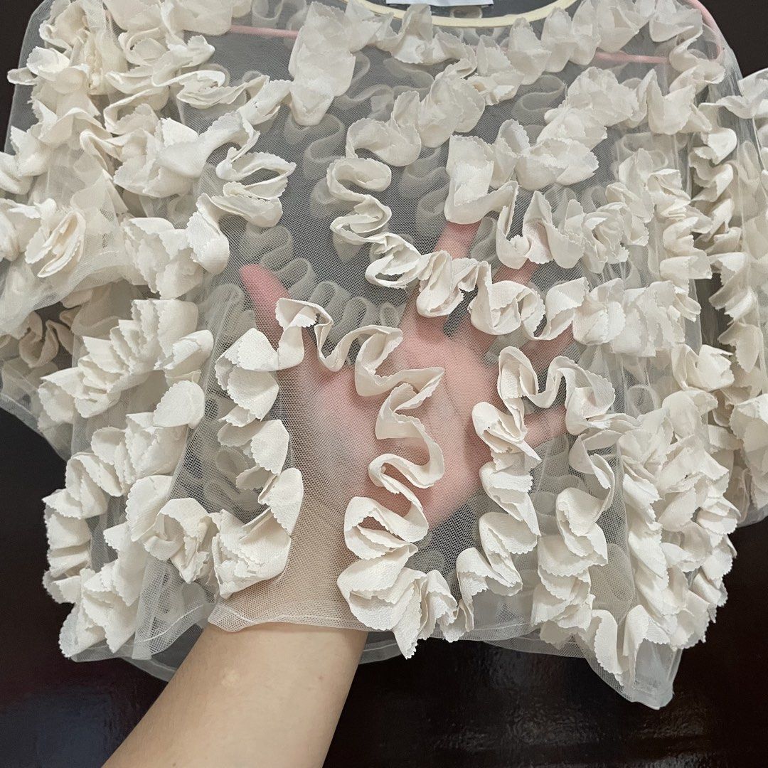 Zara Mesh Ruffle Top Cream Size S (Category: Blouses) located in Pasay City. Submitted by lovedbyzea (Listing ID 1467342551, Image 3). Description: - can fit S-M - Brand: Zara - Size: Small (Made in China) - Color: Cream with soft yellowish contrast trim - Material: Lightweight, sheer mesh fabric - Design: All-over ruffles, short sleeves, round neckline - Styling: Best worn layered over a camisole or bralette.