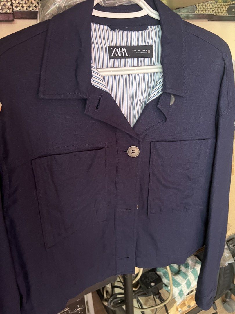 Zara Navy Blue Cropped Jacket - L (Category: Coats, Jackets and Outerwear) located in Dasmarinas. Submitted by stuffsbyklay (Listing ID 1467255851, Image 2). Description: - Brand: Zara - Color: Navy Blue - Size: L (Made in Morocco) - Design: Collared neckline with button-up front closure - Pockets: Two large front patch pockets - Details: Long sleeves with button cuffs and blue-and-white striped inner lining - Condition: Clean and well-maintained