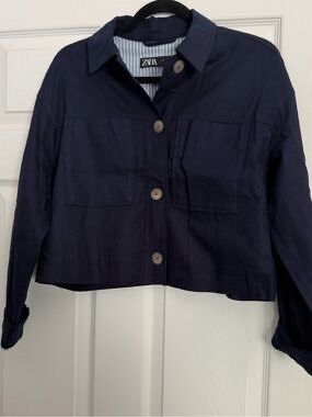 Zara Navy Blue Cropped Jacket - L (Category: Coats, Jackets and Outerwear) located in Dasmarinas. Submitted by stuffsbyklay (Listing ID 1467255851, Image 1). Description: - Brand: Zara - Color: Navy Blue - Size: L (Made in Morocco) - Design: Collared neckline with button-up front closure - Pockets: Two large front patch pockets - Details: Long sleeves with button cuffs and blue-and-white striped inner lining - Condition: Clean and well-maintained