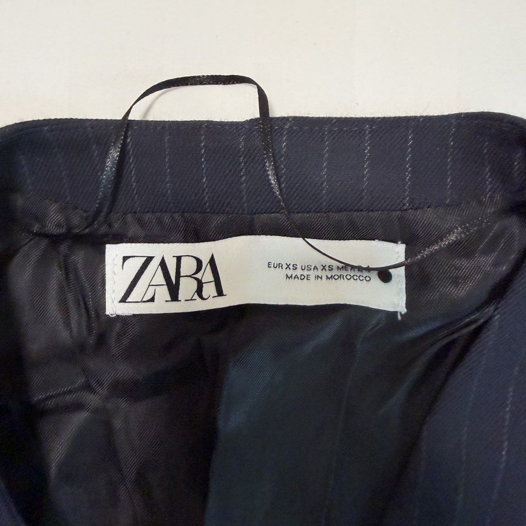 Zara Navy Pinstripe Waistcoat (Category: Sleeveless) located in Makati City. Submitted by agl.ph (Listing ID 1467359528, Image 2). Description: - Brand: Zara - Size: EUR XS / USA XS - Never used - Color: Dark blue with pinstripes - Details: Four front buttons, two front slip pockets, fully lined - Origin: Made in Morocco - Style: Classic tailoring, ideal for layering or wearing solo.
