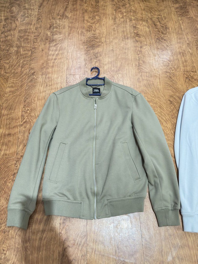Zara Olive Green Bomber Jacket Size S (Category: Coats, Jackets and Outerwear) located in Cainta. Submitted by dj_tom (Listing ID 1467255426, Image 1). Description: - Brand: Zara - Color: Olive Green - Size: Small (S) - Features: Full zip front, ribbed collar, cuffs, and hem, two front welt pockets - Perfect as a stylish transitional layer for cooler weather.