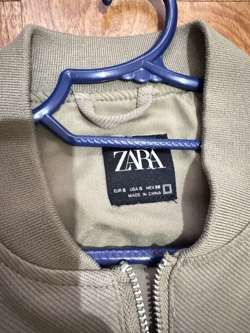 Zara Olive Green Bomber Jacket Size S (Category: Coats, Jackets and Outerwear) located in Cainta. Submitted by dj_tom (Listing ID 1467255426, Image 2). Description: - Brand: Zara - Color: Olive Green - Size: Small (S) - Features: Full zip front, ribbed collar, cuffs, and hem, two front welt pockets - Perfect as a stylish transitional layer for cooler weather.