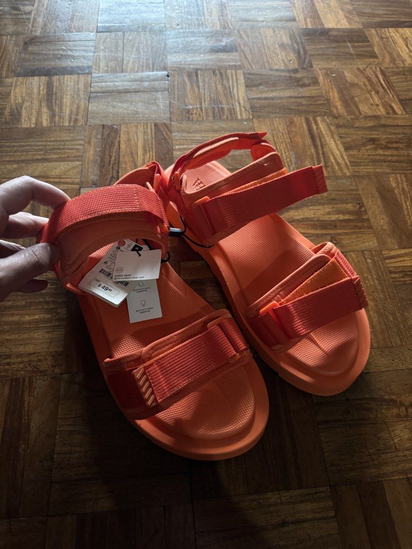 Zara Orange Velcro Sandals Size 45 (Category: Flats & Sandals) located in Manila. Submitted by seangoart (Listing ID 1467174739, Image 1). Description: - Brand: Zara - Style: Bright orange chunky sandals with adjustable velcro straps - Size: EUR 45 / US 12 - Condition: Brand new, never worn, crisp condition with clean treads - Extras: Original retail tag attached ($49.90).
