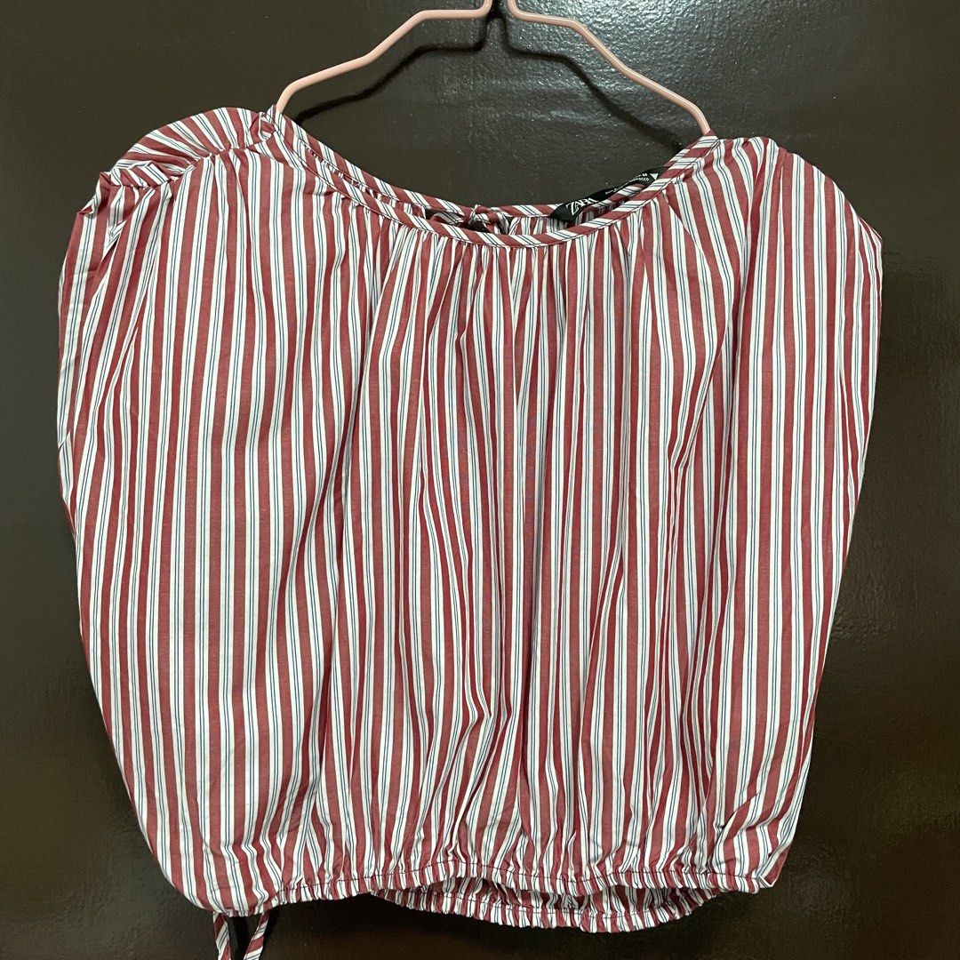 Zara Red and White Striped Blouse Size S (Category: Blouses) located in Pasay City. Submitted by lovedbyzea (Listing ID 1467343492, Image 2). Description: - Brand: Zara - Size: S (EUR S, USA S, MEX 26) - Color: Red, white, and blue stripes - Material: Lightweight cotton (Made in Morocco) - Design: Short sleeves, boat neckline with back tie closure - Detail: Elastic hem with adjustable drawstring tie.