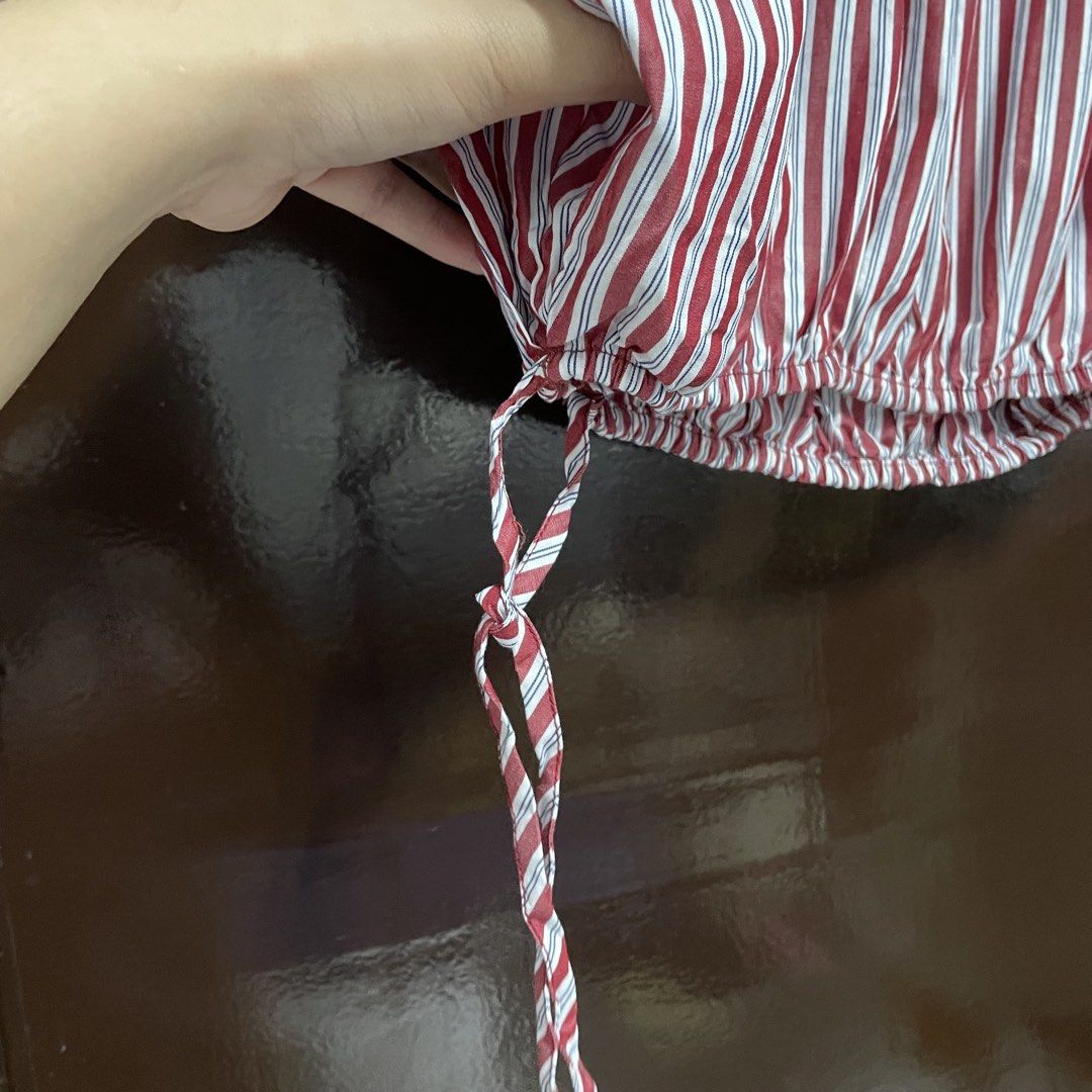 Zara Red and White Striped Blouse Size S (Category: Blouses) located in Pasay City. Submitted by lovedbyzea (Listing ID 1467343492, Image 3). Description: - Brand: Zara - Size: S (EUR S, USA S, MEX 26) - Color: Red, white, and blue stripes - Material: Lightweight cotton (Made in Morocco) - Design: Short sleeves, boat neckline with back tie closure - Detail: Elastic hem with adjustable drawstring tie.