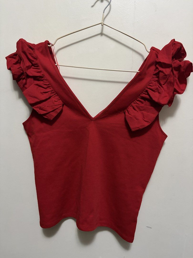 Zara Trafaluc Red Ruffle Strap Top (Category: Sleeveless) located in Quezon City. Submitted by j.steffy (Listing ID 1467327417, Image 1). Description: - Brand: Zara Trafaluc - Color: Bright red - Size: Small - Material: Lightweight knit fabric - Features: Ruffled straps, V-neckline - Origin: Made in Morocco - Season: Spring/Summer collection - Condition: Excellent, easy to pair with jeans or skirts.