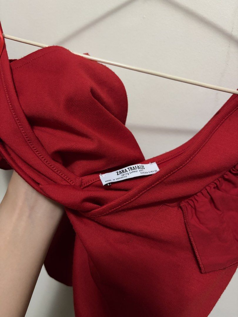 Zara Trafaluc Red Ruffle Strap Top (Category: Sleeveless) located in Quezon City. Submitted by j.steffy (Listing ID 1467327417, Image 2). Description: - Brand: Zara Trafaluc - Color: Bright red - Size: Small - Material: Lightweight knit fabric - Features: Ruffled straps, V-neckline - Origin: Made in Morocco - Season: Spring/Summer collection - Condition: Excellent, easy to pair with jeans or skirts.