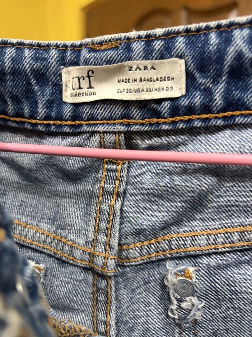 Zara TRF Blue Denim Jeans (Category: Jeans) located in Calamba. Submitted by handpickedbynetty (Listing ID 1467224187, Image 2). Description: - Brand: Zara TRF - Style: High-waisted blue denim jeans with raw, frayed ankle hems - Closure: Front button and zipper - Pockets: Classic front and back pockets - Size: EUR 32, USA 00, MEX 22 - Made in: Bangladesh - Condition: Preloved, well-kept from personal closet (no longer fits).